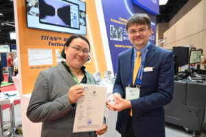 Dr Gia Ngoc Phung (PTB, Germany) passes the TCS-050-100-W Calibration Substrates Certificate to MPI Corporation
